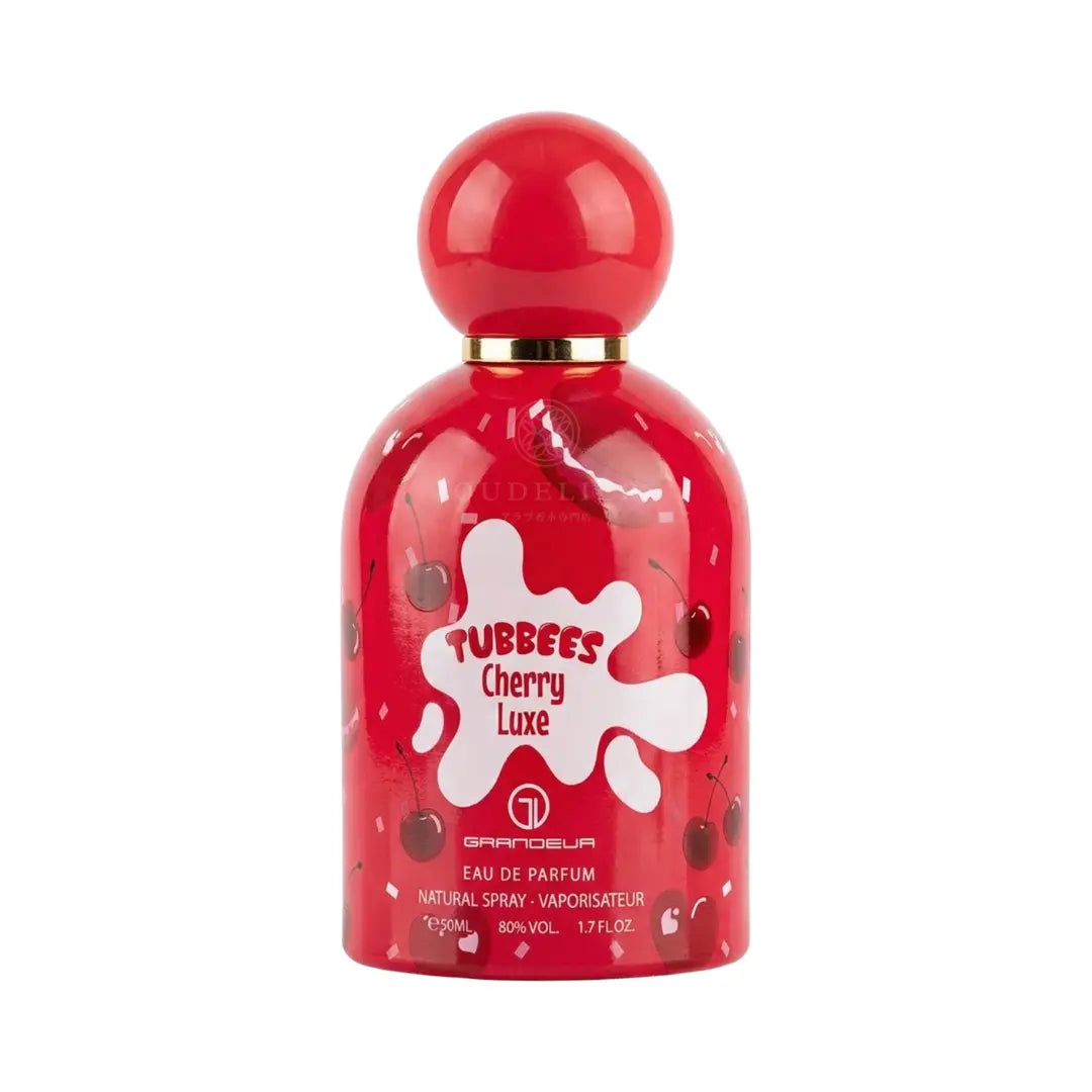 Red perfume bottle with a rounded cap, adorned with cherry graphics and white splashes. The bottle is labeled "Tubbees Cherry Luxe." Playful and vibrant design.