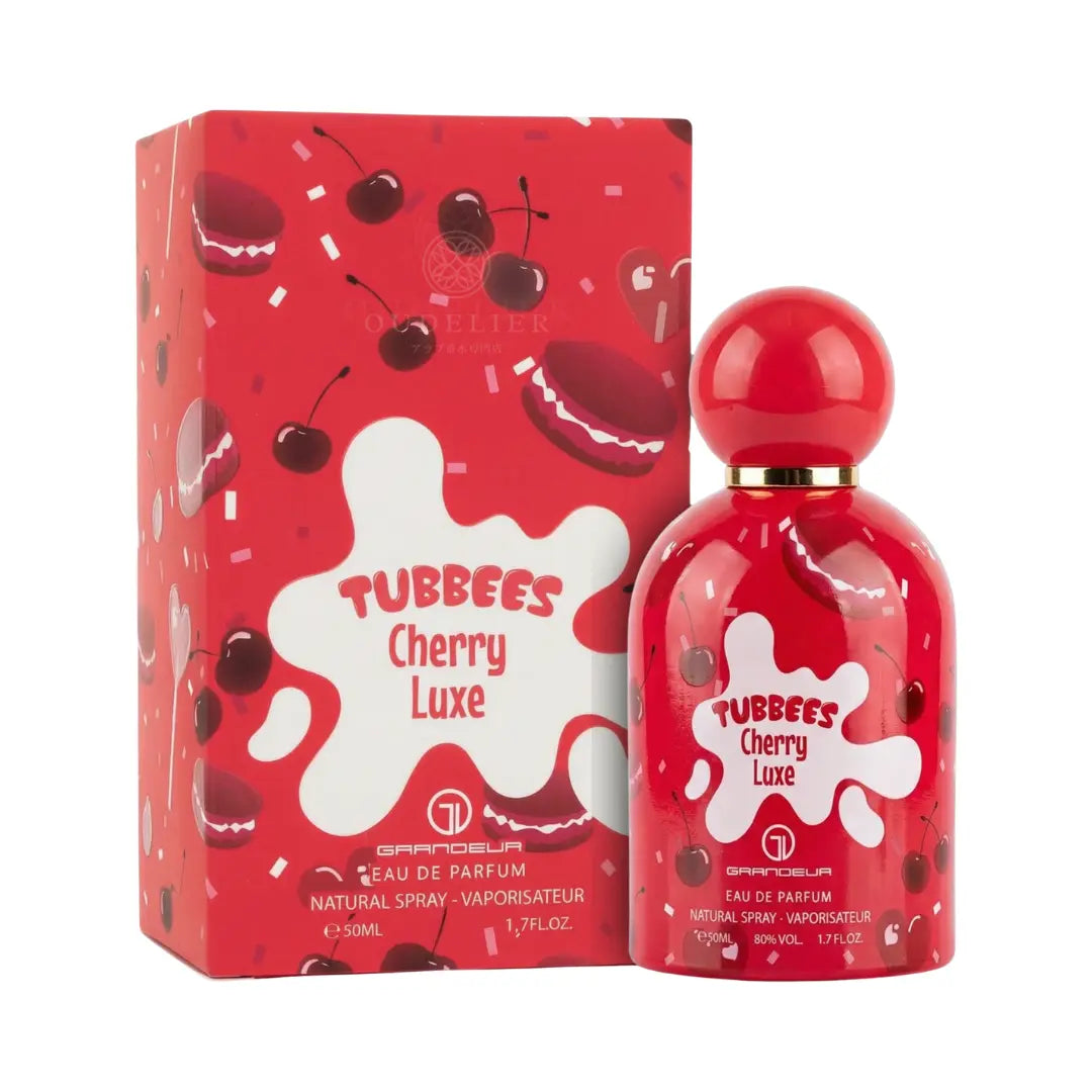 Red perfume bottle and matching box with a playful cherry design and white splashes. Text reads "Tubbees Cherry Luxe" in bold, fun font.